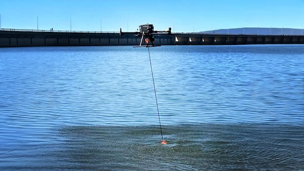 Drone with echo sounder surveying water near bridge, commercial drone for industrial survey