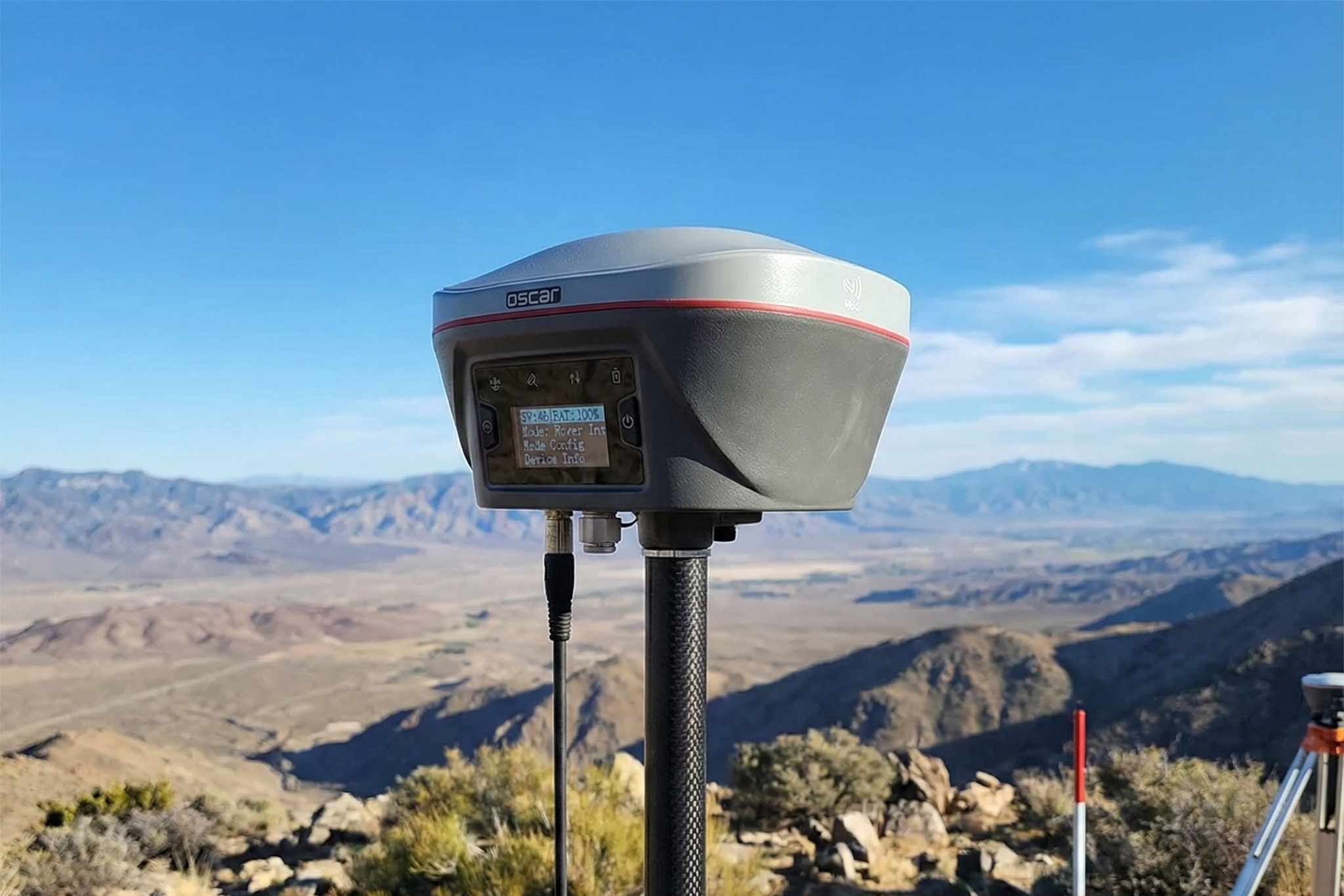 GNSS survey equipment on tripod in rocky mountain landscape, AlphaGeo survey technology