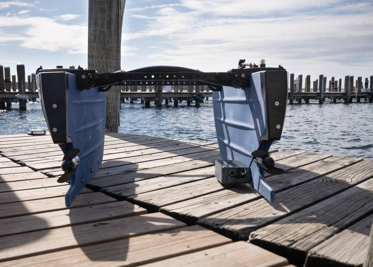 Dual-fin underwater drone on wooden dock by water, AlphaGeo Ltd marine robotics equipment