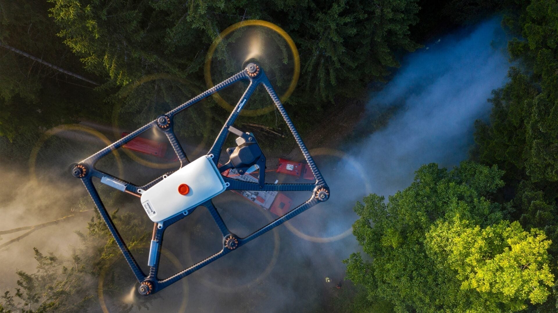 Commercial drone flying over forest during survey with AlphaGeo survey equipment