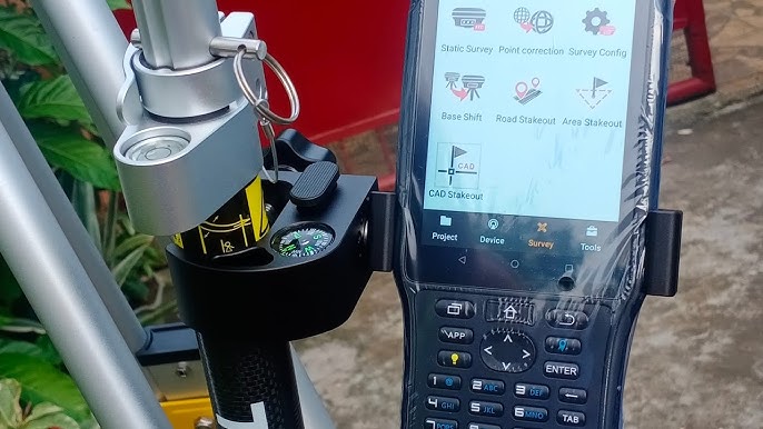 Survey equipment data collector with screen interface and compass, used for land surveying by AlphaGeo Ltd.