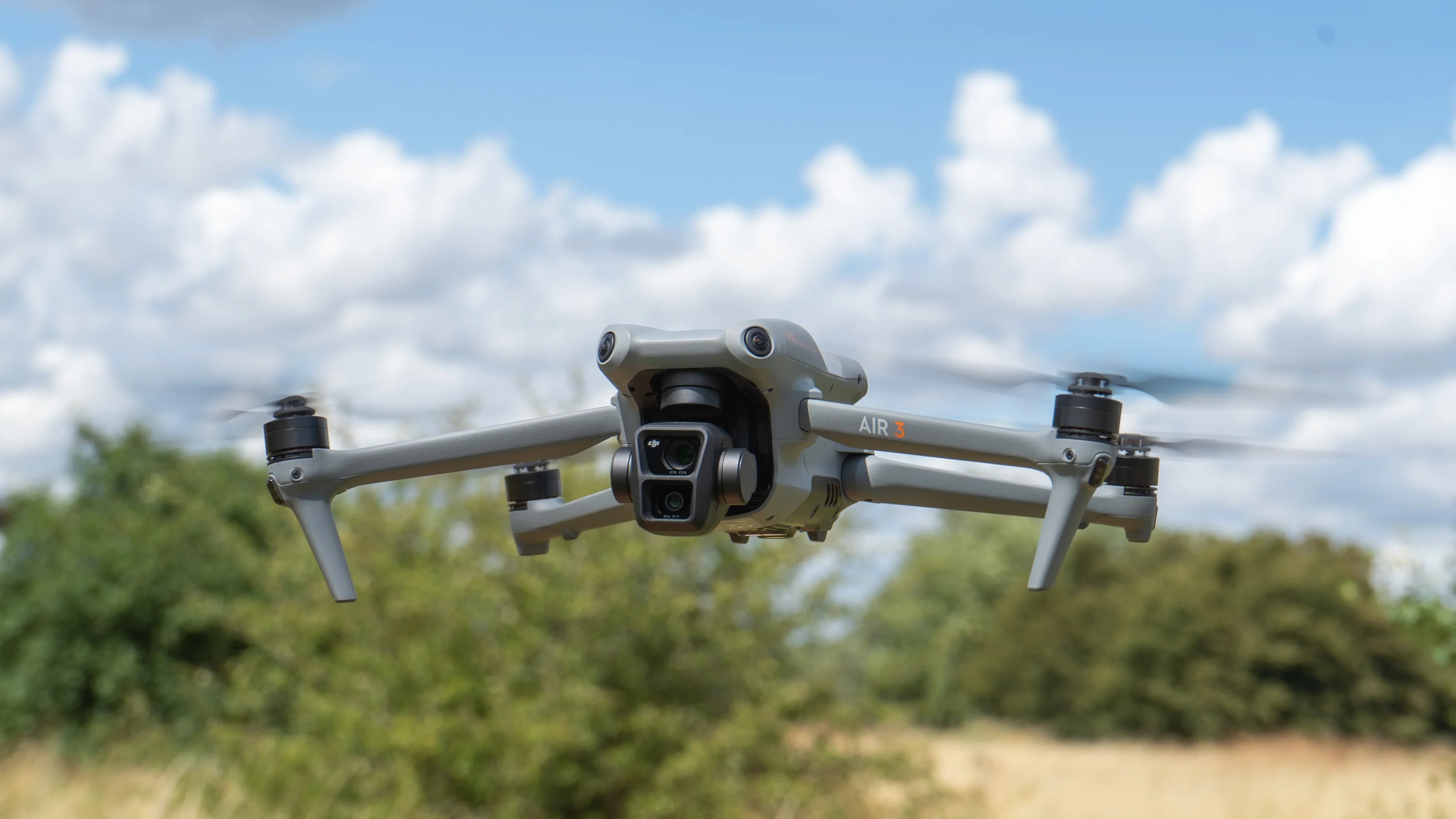 DJI Air 3 drone in flight outdoors, commercial UAV available at AlphaGeo Oxfordshire UK